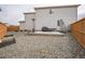 Well-kept backyard featuring gravel landscaping, modern fencing, patio with heater, and a raised garden bed at 11677 Park South Ln, Parker, CO 80138