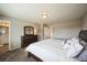 This carpeted main bedroom has a dark dresser and an open doorway to the bathroom at 11677 Park South Ln, Parker, CO 80138
