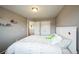 This carpeted bedroom features a white framed bed, white double door closet, and an open doorway at 11677 Park South Ln, Parker, CO 80138