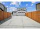 Spacious driveway leading to a two-car garage, bordered by a wood fence at 11677 Park South Ln, Parker, CO 80138