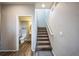 Hallway with stairs leading upstairs and a half-bathroom to the left at 11677 Park South Ln, Parker, CO 80138