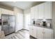 Kitchen with stainless steel appliances, granite counters, white cabinets, and modern fixtures at 11677 Park South Ln, Parker, CO 80138