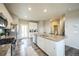 Well-lit kitchen boasts stainless appliances, granite counters, a center island with seating, and access to the backyard at 11677 Park South Ln, Parker, CO 80138