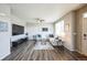 Cozy living room with stylish decor, hardwood floors, and a large flat-screen television at 11677 Park South Ln, Parker, CO 80138