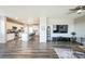 Open-concept living space with a modern kitchen, island seating, and hardwood floors at 11677 Park South Ln, Parker, CO 80138