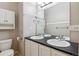 Bathroom featuring a double sink with black counter and a big mirror for a bright space at 9351 Amison Cir # 104, Parker, CO 80134
