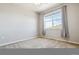 Bedroom featuring neutral carpet, light walls, and a big window with elegant curtains at 9351 Amison Cir # 104, Parker, CO 80134