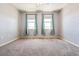 Spacious bedroom featuring neutral walls, two windows with coverings and carpet at 9351 Amison Cir # 104, Parker, CO 80134