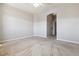 Bedroom showcasing plush carpet, light-gray walls, and an arched doorway to other rooms at 9351 Amison Cir # 104, Parker, CO 80134