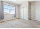 Bedroom featuring neutral carpet, light walls, a big window, and a closet at 9351 Amison Cir # 104, Parker, CO 80134
