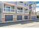Exterior building featuring garages, balconies and brick accents at 9351 Amison Cir # 104, Parker, CO 80134