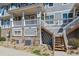 Townhouse exterior featuring stone accents and private wooden staircase at 9351 Amison Cir # 104, Parker, CO 80134