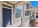 Front porch with unit number, wooden railing, and stairs at 9351 Amison Cir # 104, Parker, CO 80134