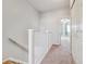 Carpeted upstairs hallway with white railing, neutral walls, and carpet at 9351 Amison Cir # 104, Parker, CO 80134