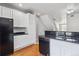 Bright kitchen featuring black appliances, granite countertops, and white cabinets at 9351 Amison Cir # 104, Parker, CO 80134