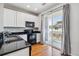 Modern kitchen with black appliances and countertops adjacent to patio with sliding glass door at 9351 Amison Cir # 104, Parker, CO 80134
