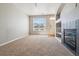 Cozy living room with fireplace, neutral carpet, and ample natural light at 9351 Amison Cir # 104, Parker, CO 80134