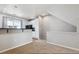 Open living room view into kitchen with breakfast bar and natural light at 9351 Amison Cir # 104, Parker, CO 80134