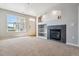 Bright living room with a fireplace, built-in shelves and neutral carpet at 9351 Amison Cir # 104, Parker, CO 80134