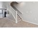 Carpeted staircase with white railing, leading to upper level at 9351 Amison Cir # 104, Parker, CO 80134