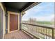 Balcony with a wood floor and railing, with a view overlooking a green space at 804 Summer Hawk Dr # 303, Longmont, CO 80504