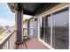 Balcony with wood floor and white railing, and glass sliding doors at 804 Summer Hawk Dr # 303, Longmont, CO 80504