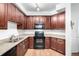 Bright kitchen features wood cabinets, stone countertops, and updated appliances at 804 Summer Hawk Dr # 303, Longmont, CO 80504