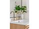 Up close view of modern bathroom faucet and decor against a mirrored backdrop at 7050 W Cedar Ave # 108, Lakewood, CO 80226