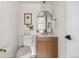 Chic powder room with modern vanity, arched mirror, and stylish fixtures at 7050 W Cedar Ave # 108, Lakewood, CO 80226