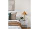 Bedroom with bedside table, stylish lamp, and decor, enhancing the room's cozy ambiance at 7050 W Cedar Ave # 108, Lakewood, CO 80226