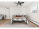 Bright bedroom boasts a full-size bed, ceiling fan, mirrored closet, and large window at 7050 W Cedar Ave # 108, Lakewood, CO 80226