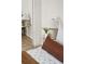 Bright bedroom featuring a full-length mirror, end table, decorative lamp, and neutral decor at 7050 W Cedar Ave # 108, Lakewood, CO 80226