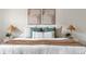 Bedroom showcasing a well-dressed bed with decorative pillows, bedside lamps, and wall art at 7050 W Cedar Ave # 108, Lakewood, CO 80226