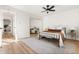 Bright bedroom boasts a full-size bed, ceiling fan, mirrored closet, and hardwood floors at 7050 W Cedar Ave # 108, Lakewood, CO 80226
