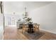 Open concept dining area featuring a round table, modern chandelier, and an adjacent kitchen at 7050 W Cedar Ave # 108, Lakewood, CO 80226