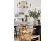 Bright dining area featuring hardwood floors and a modern chandelier at 7050 W Cedar Ave # 108, Lakewood, CO 80226