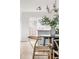 Bright dining area featuring hardwood floors and a modern chandelier at 7050 W Cedar Ave # 108, Lakewood, CO 80226