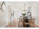Dining area with a black round table, wood chairs, chandelier, and access to the kitchen at 7050 W Cedar Ave # 108, Lakewood, CO 80226