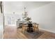 Dining room showcasing wood chairs, a dark table, and a view of the modern kitchen at 7050 W Cedar Ave # 108, Lakewood, CO 80226