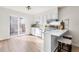 Open concept kitchen featuring stainless steel appliances, a breakfast bar, and sliding glass door at 7050 W Cedar Ave # 108, Lakewood, CO 80226