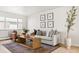 Comfortable living room with plush sofa, accent chair, stylish coffee table, and ample natural light at 7050 W Cedar Ave # 108, Lakewood, CO 80226