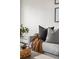 Living room featuring throw pillows, a brown blanket and a decorative basket on the table at 7050 W Cedar Ave # 108, Lakewood, CO 80226