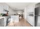 The open-concept living space includes a kitchen with stainless appliances and connects to living and dining areas at 7050 W Cedar Ave # 108, Lakewood, CO 80226