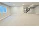 Finished basement with neutral carpet and a staircase at 6023 Chester Way, Denver, CO 80238