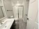 Modern bathroom features a glass-enclosed shower and a sleek vanity with white countertop at 6023 Chester Way, Denver, CO 80238