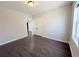 Bedroom with hardwood floors, neutral paint, and a double-door closet at 6023 Chester Way, Denver, CO 80238