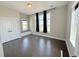Bright bedroom featuring hardwood floors, a window seat, and natural light at 6023 Chester Way, Denver, CO 80238