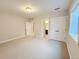 Bright bedroom features neutral walls, white trim, carpet floors, a double door closet, and an ensuite bathroom at 6023 Chester Way, Denver, CO 80238