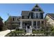 Charming two-story home boasts a welcoming front porch and beautiful landscaping, adding to its curb appeal at 6023 Chester Way, Denver, CO 80238