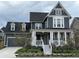 Charming two-story home boasts a welcoming front porch and beautiful landscaping, adding to its curb appeal at 6023 Chester Way, Denver, CO 80238
